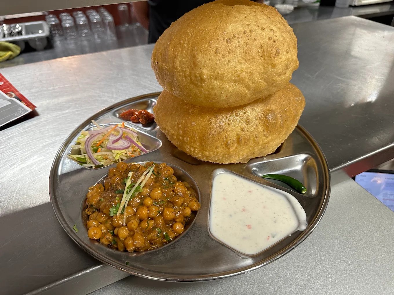 Chole bhature with chickpea curry and puffed bread at Mehfil