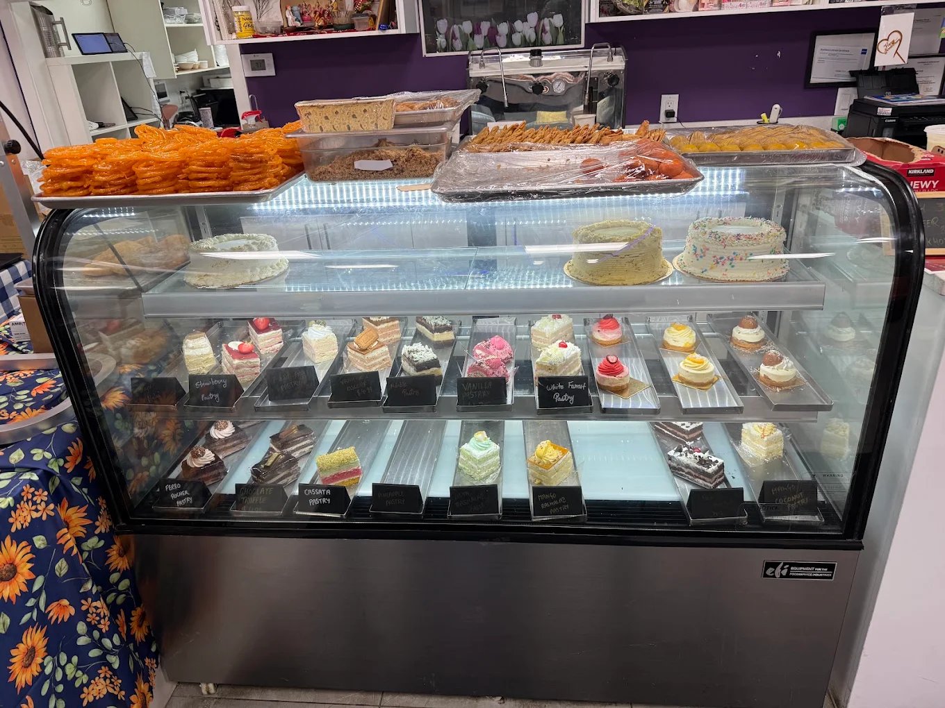 Bakery display case with pastries and cakes