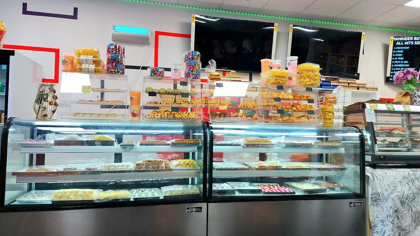 Display cases filled with Indian sweets and snacks
