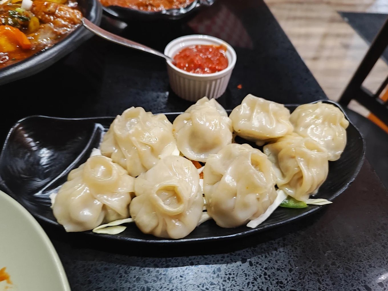 Steamed momos with spicy chutney at Mehman Calgary