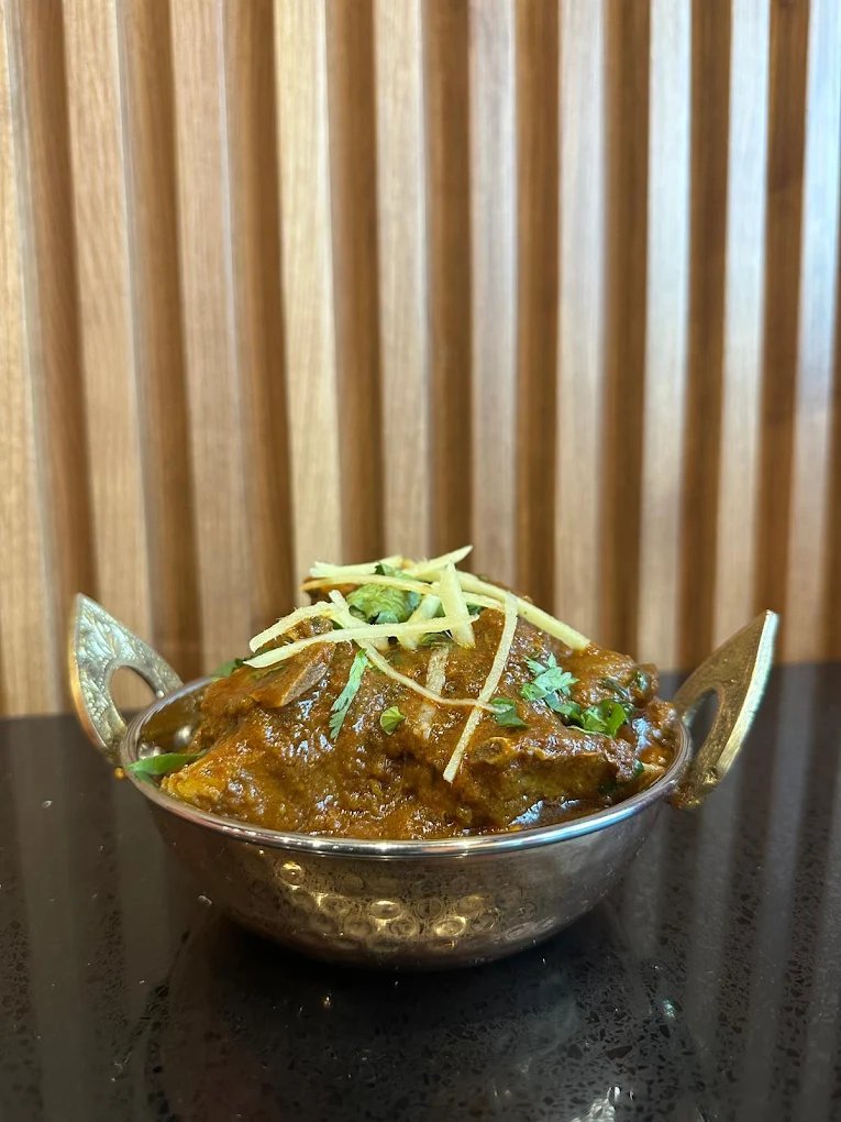 Kadai chicken curry topped with fresh ginger at Mehman Calgary