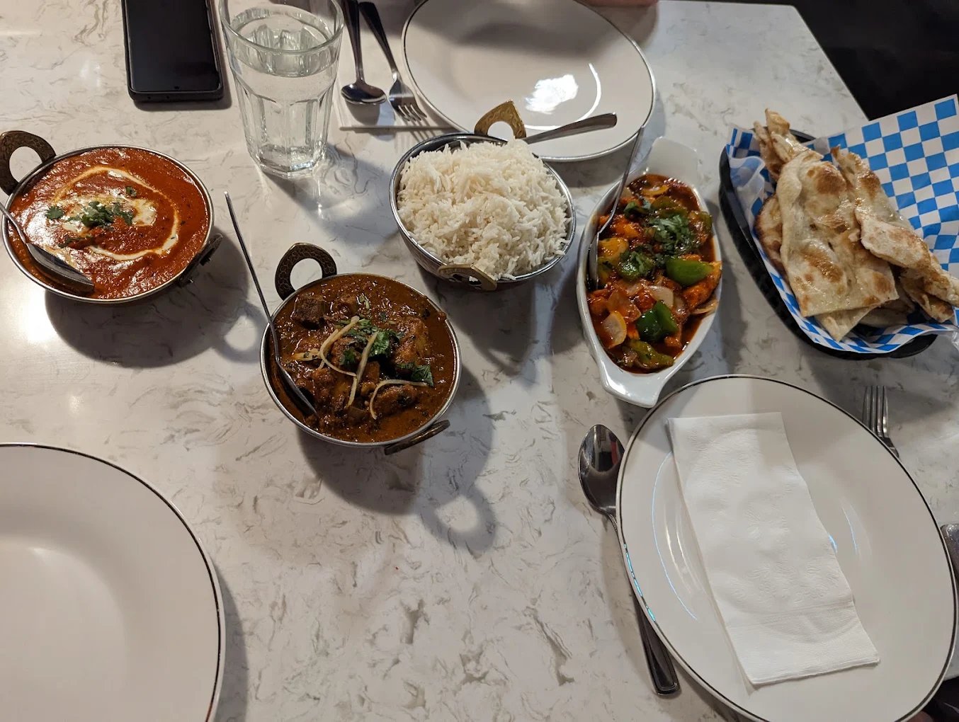 Indian feast with curries and naan at Rasoi on 50th