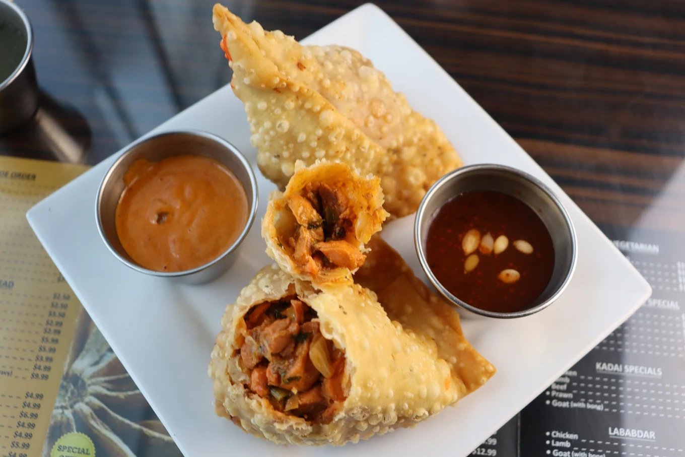 Chicken samosas served with three dipping sauces
