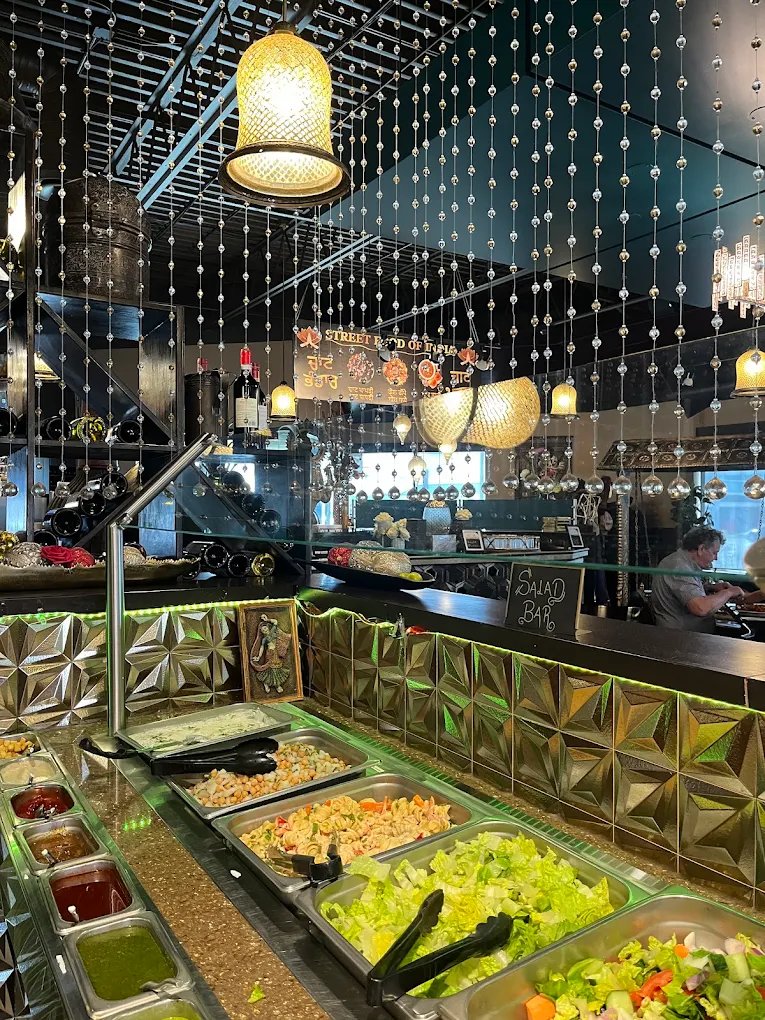 Fresh salad bar with chutneys and beaded curtains at New Asian Village Edmonton