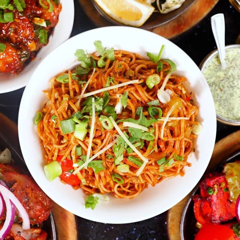 Hakka noodles garnished with green onion and ginger