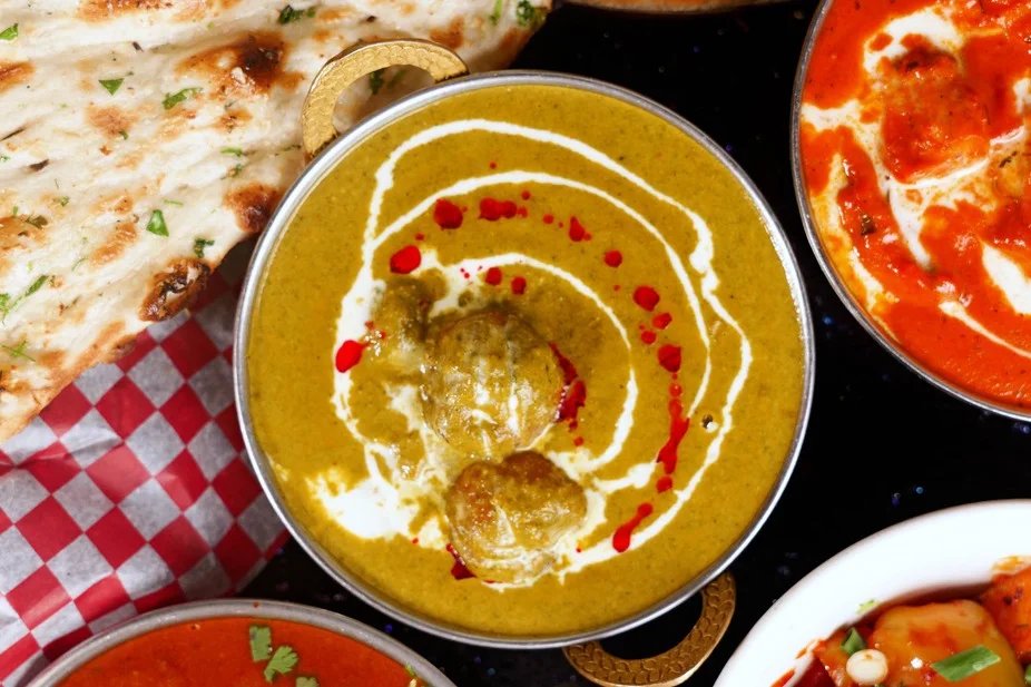 Malai kofta curry with naan and butter chicken
