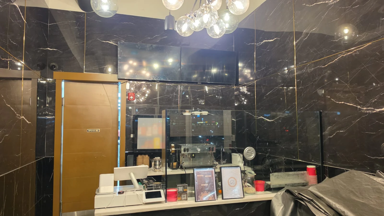 Restaurant front counter and black marble walls