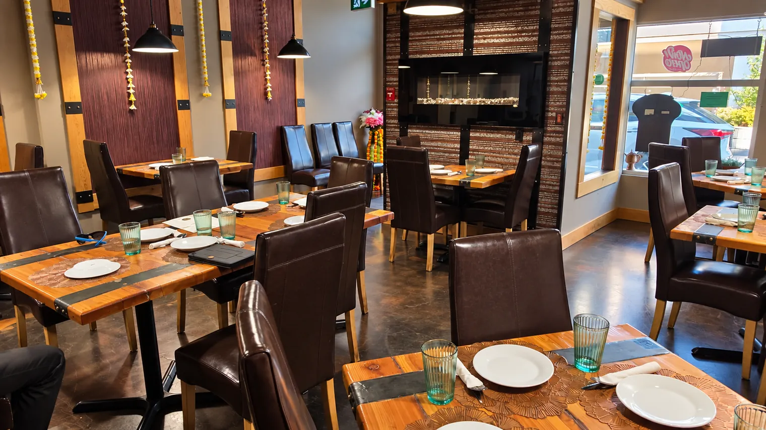 Actual Agnii dining area with wooden tables and pendant lighting
