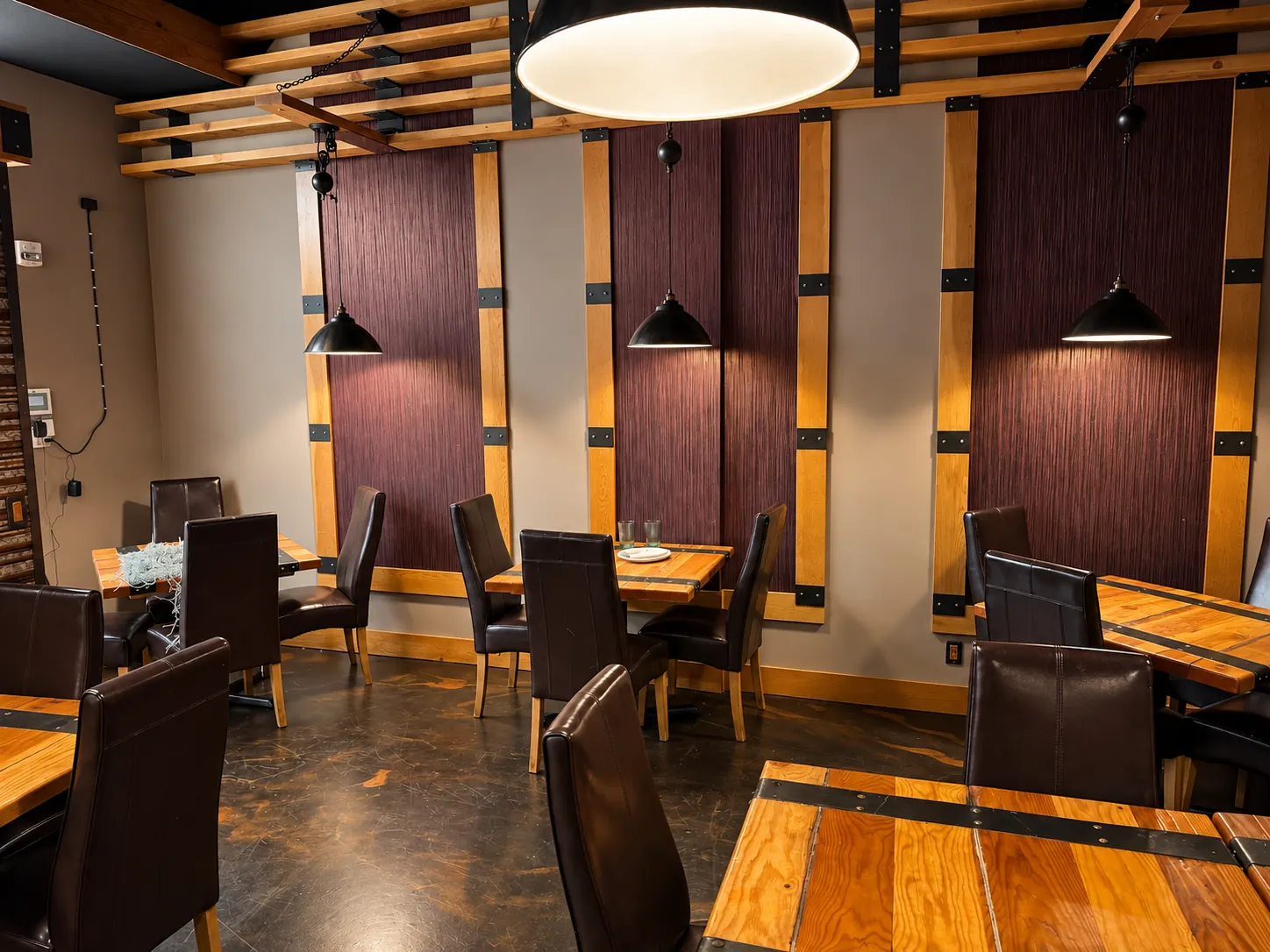 Actual Agnii dining room with wood-panel feature wall