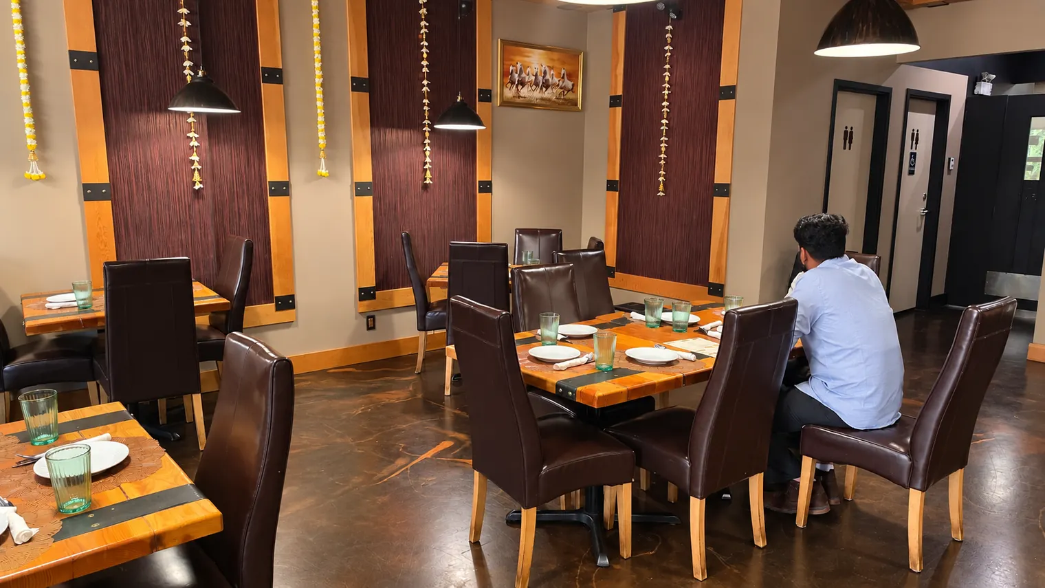 Agnii restaurant tables with a guest seated