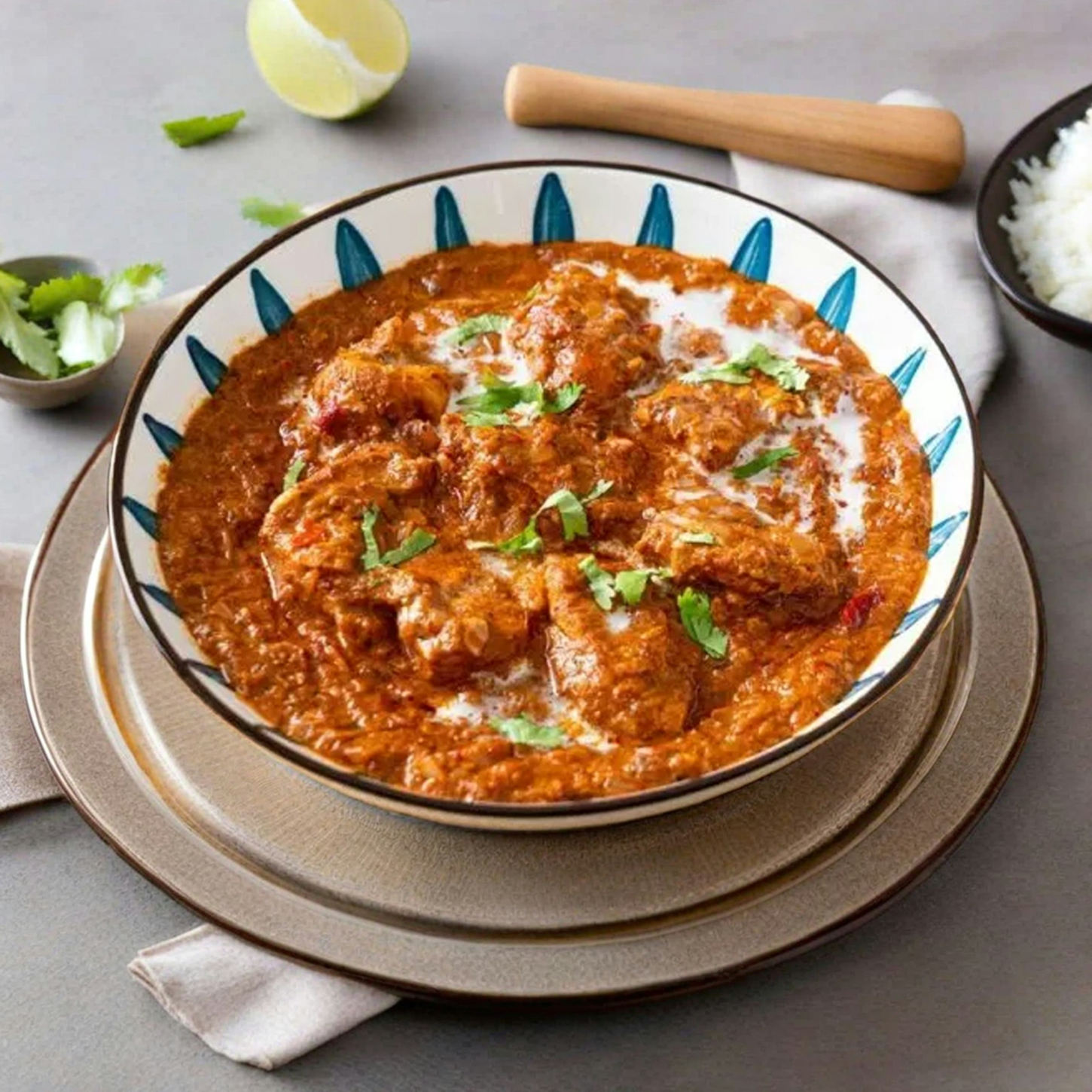 Creamy chicken curry garnished with herbs