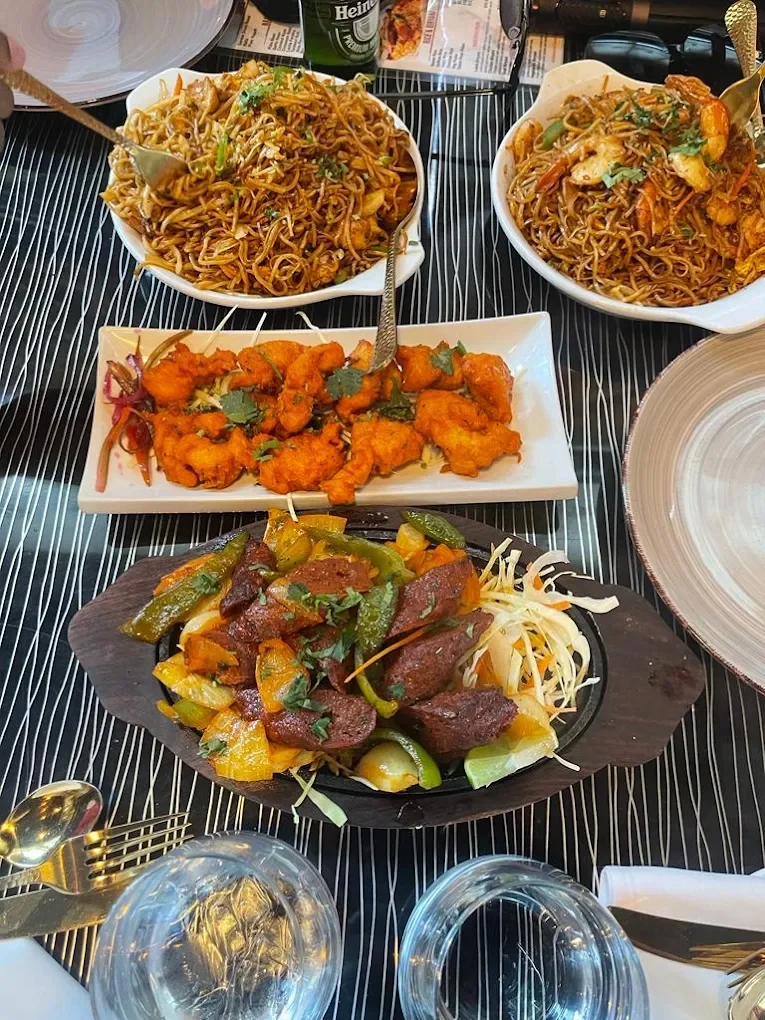 A shared meal of noodles, appetizers and a sizzling platter