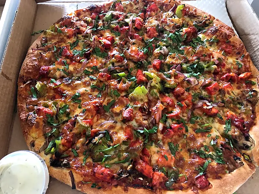 Genuine Espania Pizzeria pizza with vibrant toppings