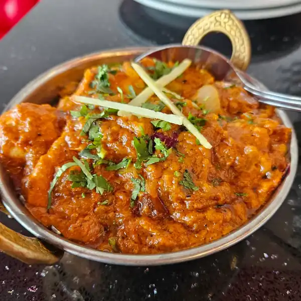 Indian curry in a copper serving bowl