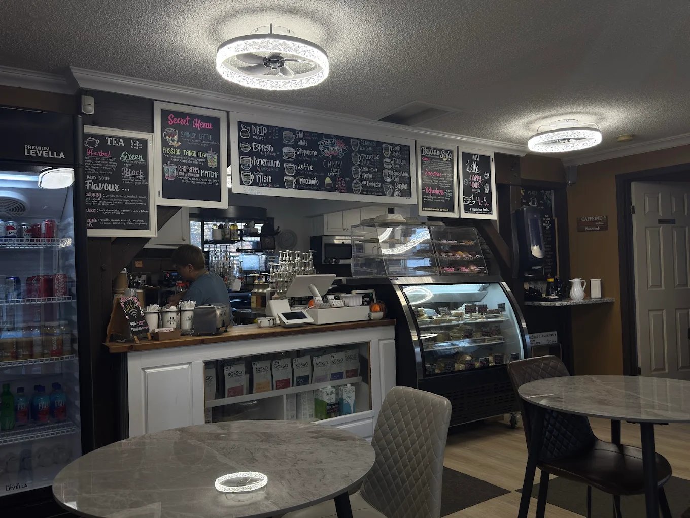 Barista at the counter and pastry case