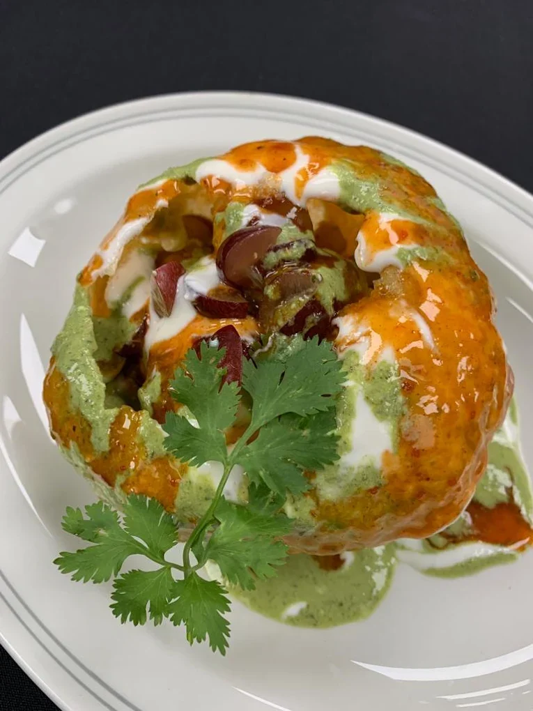 Stuffed chaat topped with yogurt and chutneys
