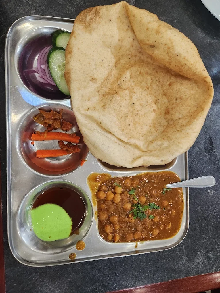 Chole bhature with salad and chutney