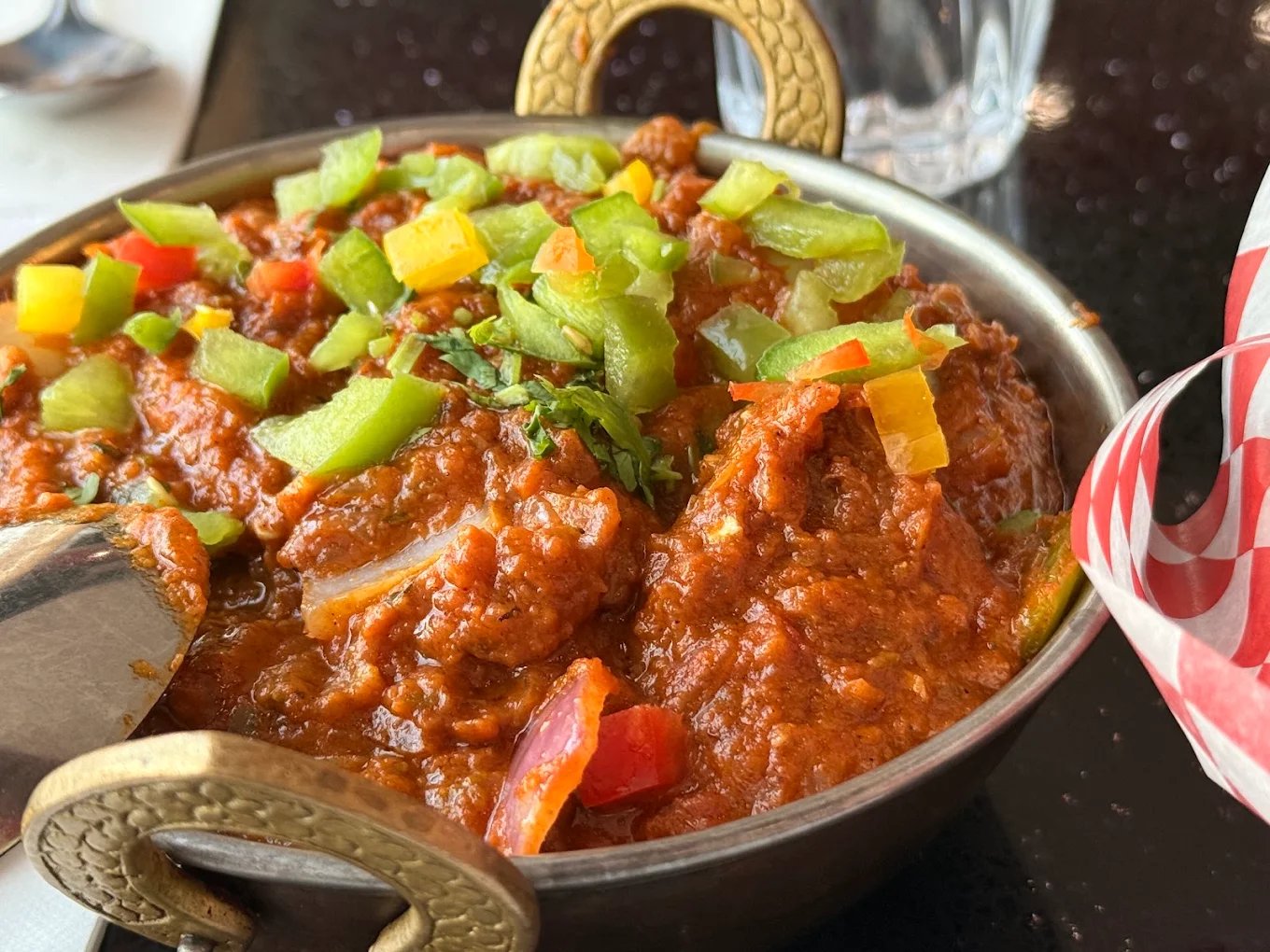 Rich curry topped with fresh peppers