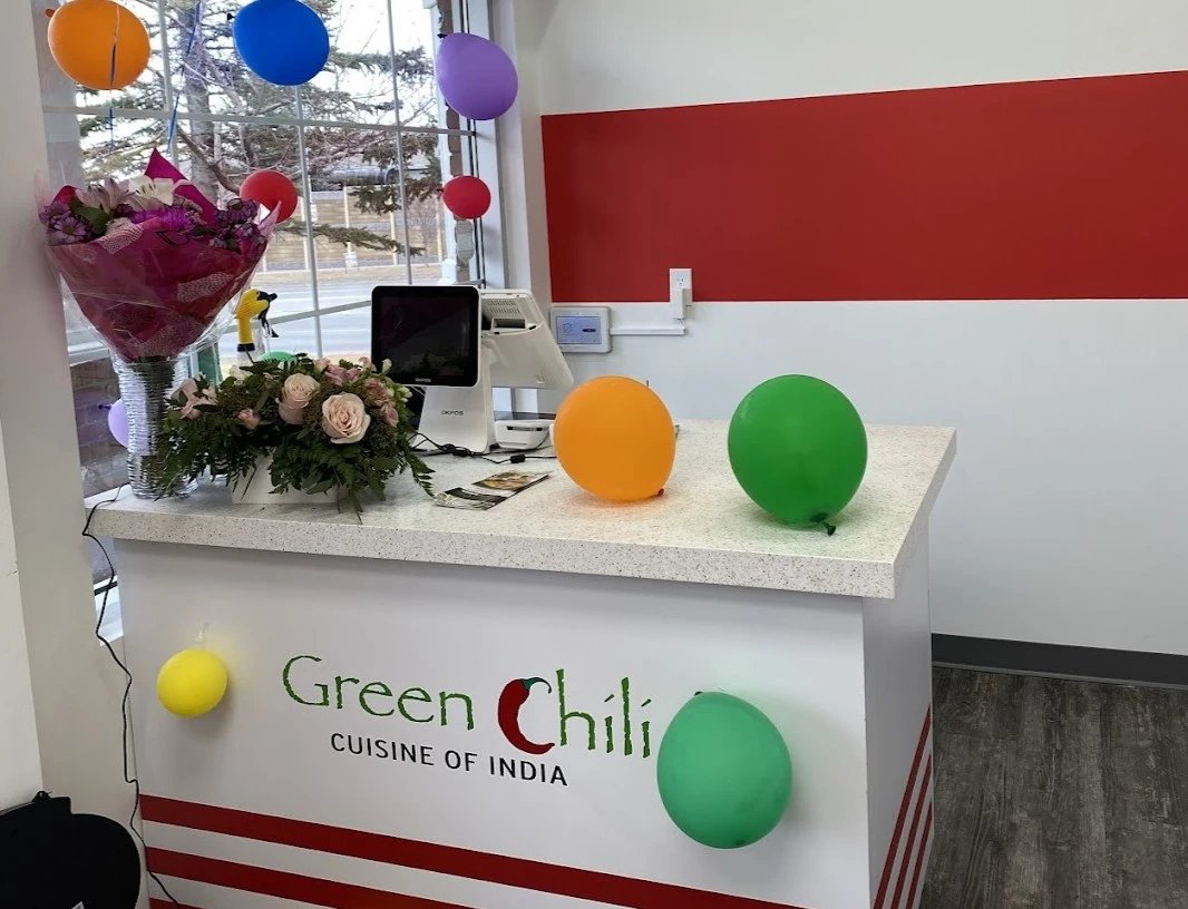 Green Chili Delight front counter with festive balloons and flowers
