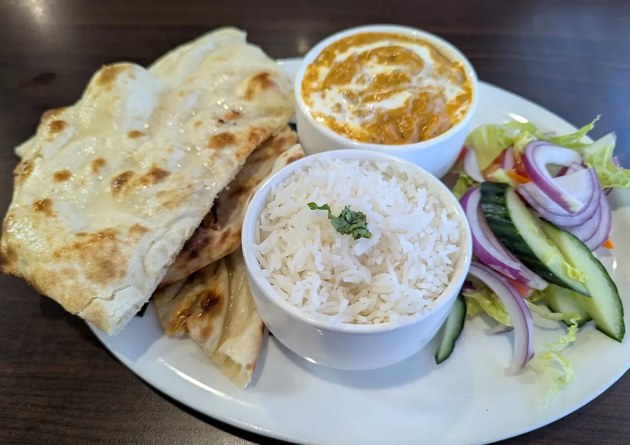 Indian curry combo with naan, rice and salad